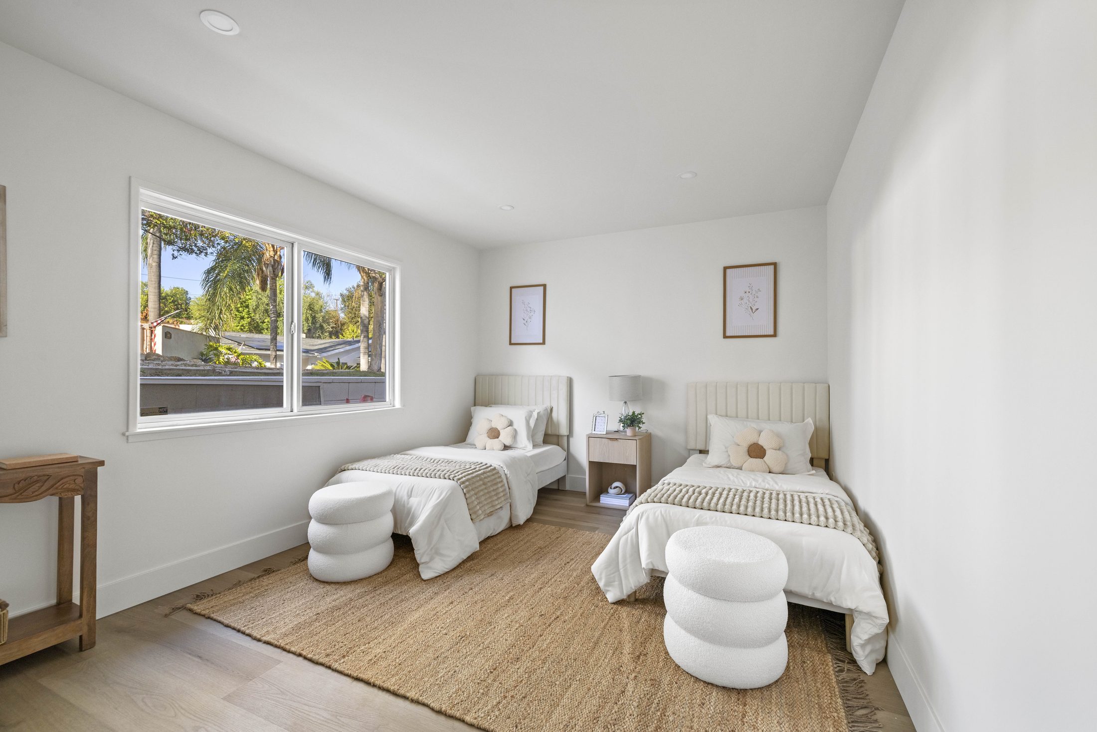 Secondary bedroom with twin beds and natural light