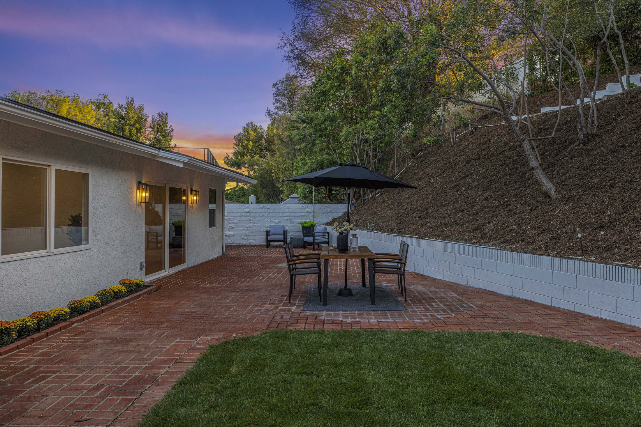 Private backyard with brick patio and lawn
